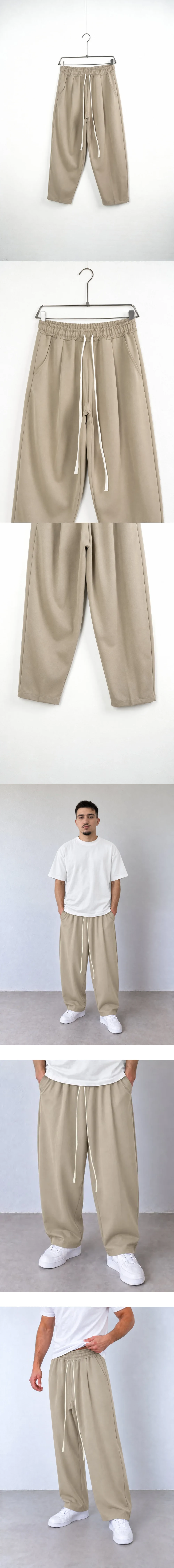 Pantaloni Bărbați Bej Largi Baggy — pantaloni baggy pe umeraș, unghi oblic — cadrul 2 din galeria editorială.