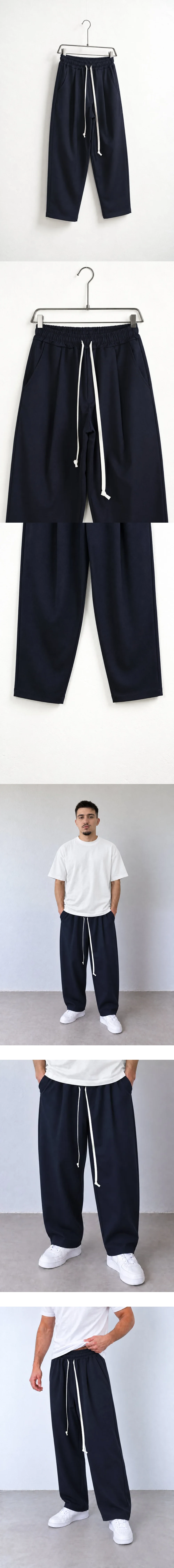 Pantaloni Bărbați Bleumarin cu Talie Elastică și Șnur — pantaloni pe umeraș, vedere oblică — cadrul 2 din galeria editorială.
