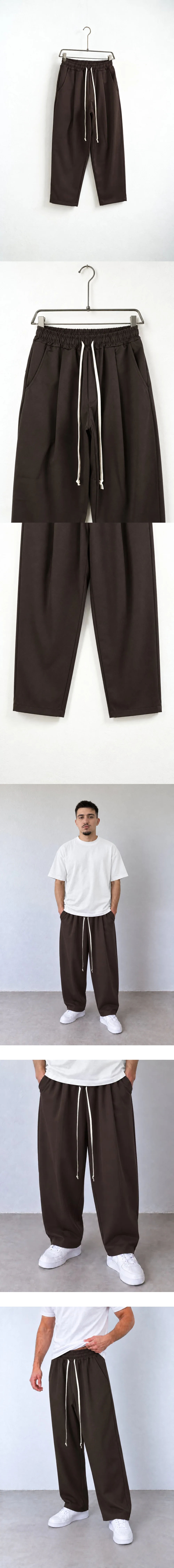Pantaloni Bărbați Maro cu Talie Elastică și Șnur — pantaloni pe umeraș, vedere oblică — cadrul 2 din galeria editorială.