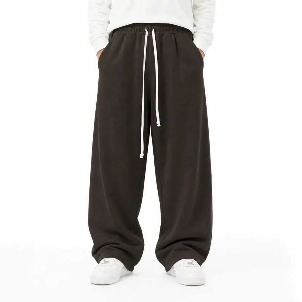 Pantaloni Lungi Largi Bărbați Maro cu Șnur Lung și Buzunar la Spate — pantaloni lungi maro pentru bărbați, croială largă, vedere din spate cu buzunar aplicat — cadrul 2 din galeria editorială.