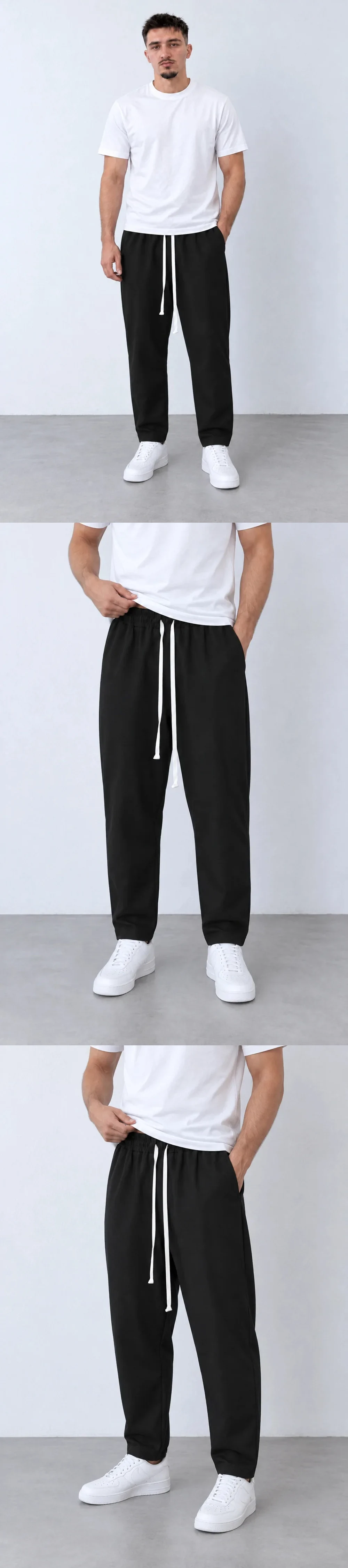 Pantaloni Lungi Ușor Slim Bărbați Negru cu Șnur Lung și Buzunar la Spate — pantaloni lungi negri carrot fit pentru bărbați, cu șnur alb lung, purtați cu tricou alb și sneakers, vedere integrală — cadrul 2 din galeria editorială.